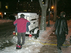 [Photo: Ed Dyer and Chris Wood working on generator.] 