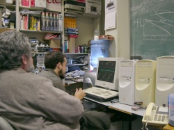 [Photo: Ed Dyer and Johnathan Thibodeau bring new mail scanners
online.] 