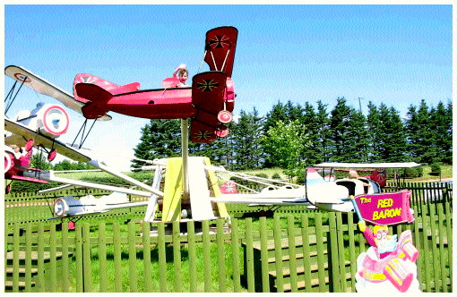 (Image: A Child Waves at the Camera from the Ride)