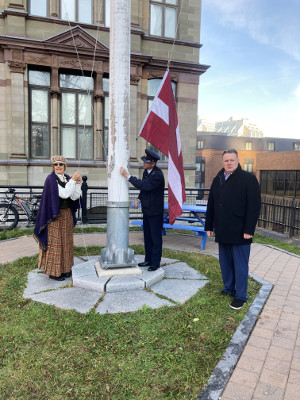 Ingrid helps to raise the Latvian flag