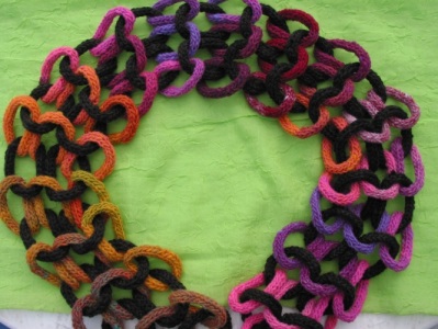 Chain d'Amour scarf knit in varous colours of wool.