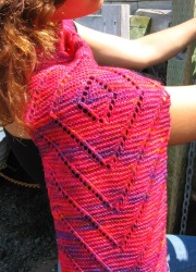 Diamond Diagonal Scarf knit in very bright pinks with just a little purple.