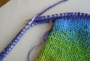 The working yarn has been knit across the second side of the sleeve