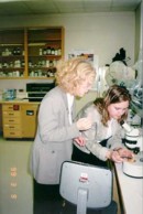 MP for Dartmouth, Wendy Lill, viewing benthic macroinvertebrates collected by biologist, Monica Gaertner, at the NRC labs; winter of 1999