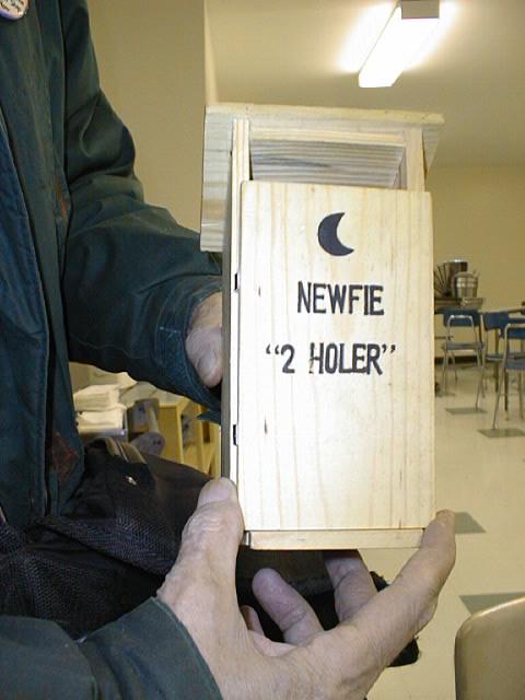 [A picture of an outhouse with "NEWFIE 2-HOLER" on the door.]