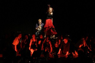 (Image: The Full Cast Performs the Title Number Surrounding a 
  Trumpet Player and Dancer on a Table)