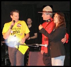 (Image: A Radio Announcer and RCMP Officer on Stage with Julia
 at the first Maritime Beatle Event)