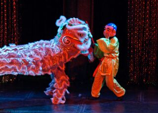 (Image: A Colourful Dragon Dances with an Actor in a Traditional
  Asian Costume)