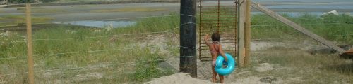child, barbed wire and beach